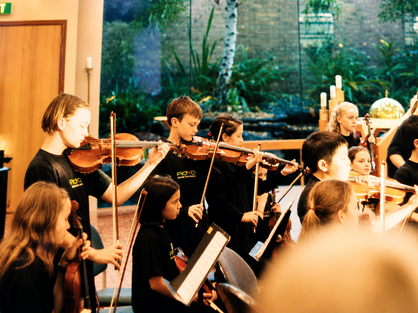 Young musicians performing in a string orchestra.
